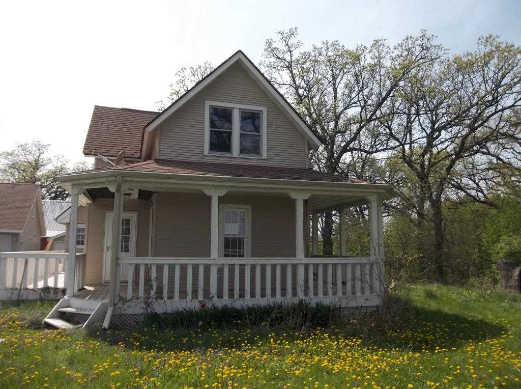 8770 North Kilbuck Road Monroe Center, IL 61052 - Photo 2 of 18 a view of a house with a yard and large trees