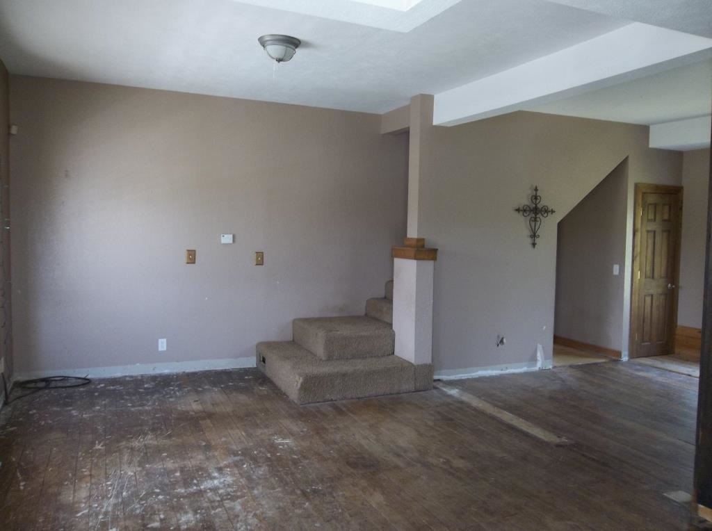 8770 North Kilbuck Road Monroe Center, IL 61052 - Photo 8 of 18 an empty room with staircase and white walls
