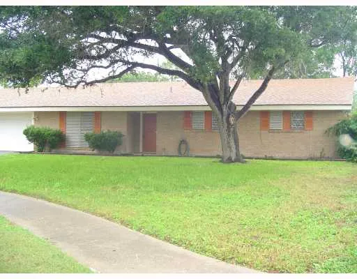 a front view of house with yard and green space