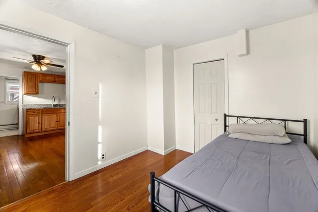 a view of a room that has a bed and a table in it