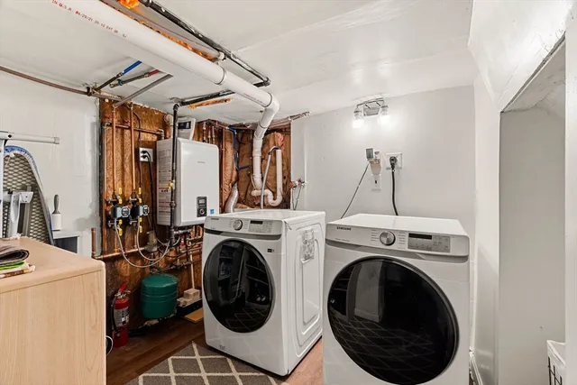 a view of a storage & utility room with dryer and washer