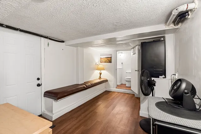 a room with wooden floor and gym equipment