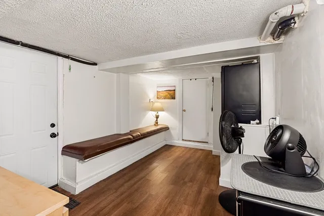 a view of a room with wooden floor and furniture