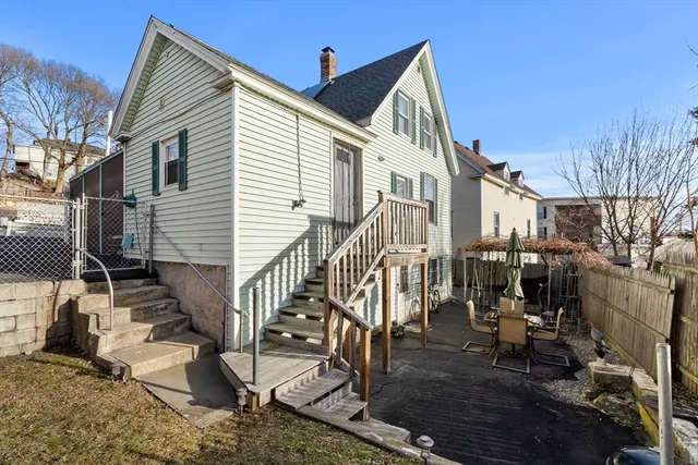 a view of a house with wooden deck front of house