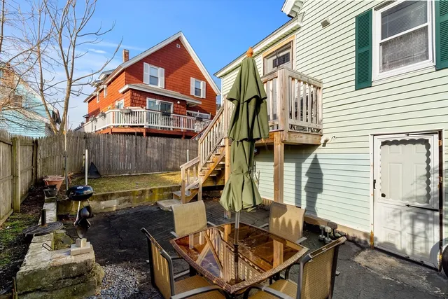 a view of a house with backyard and sitting area