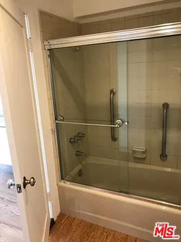 a bathroom with a shower and a bathtub