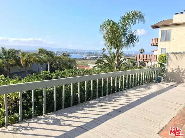 a view of a balcony with wooden floor