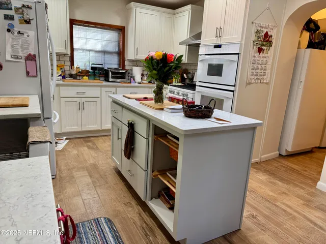 a kitchen with a sink cabinets and appliances