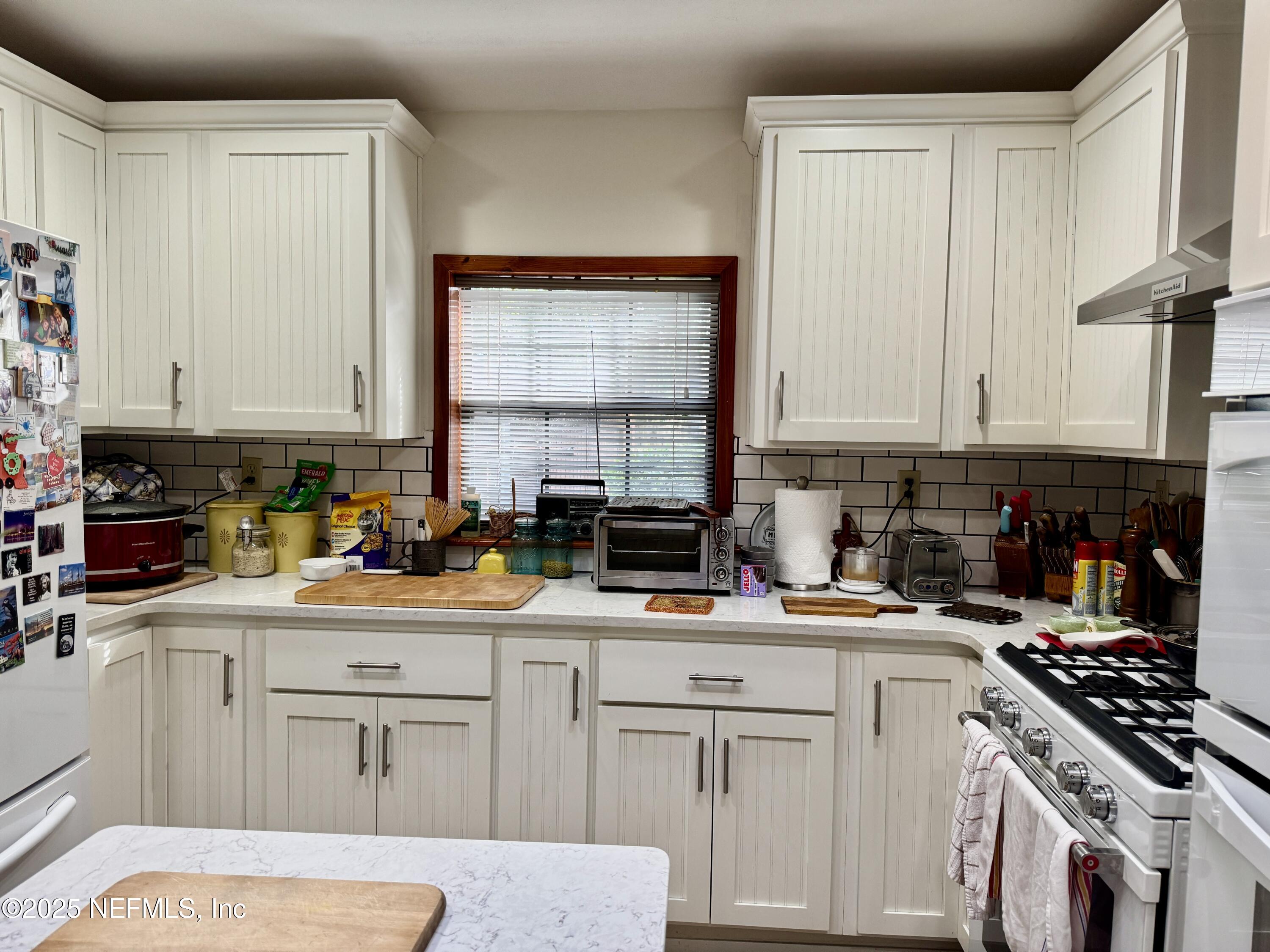 116 Francis Street Interlachen, FL 32148 - Photo 22 of 45 a kitchen with cabinets appliances a sink and a counter top space