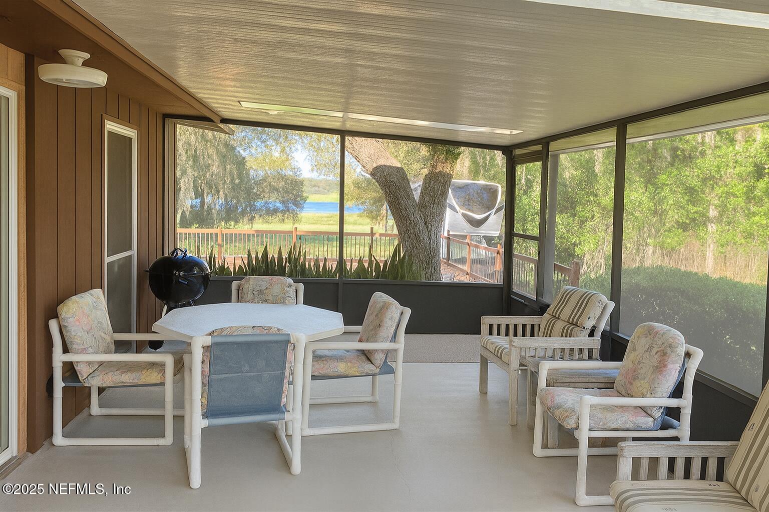 116 Francis Street Interlachen, FL 32148 - Photo 25 of 45 a dining room with furniture large windows and a chandelier