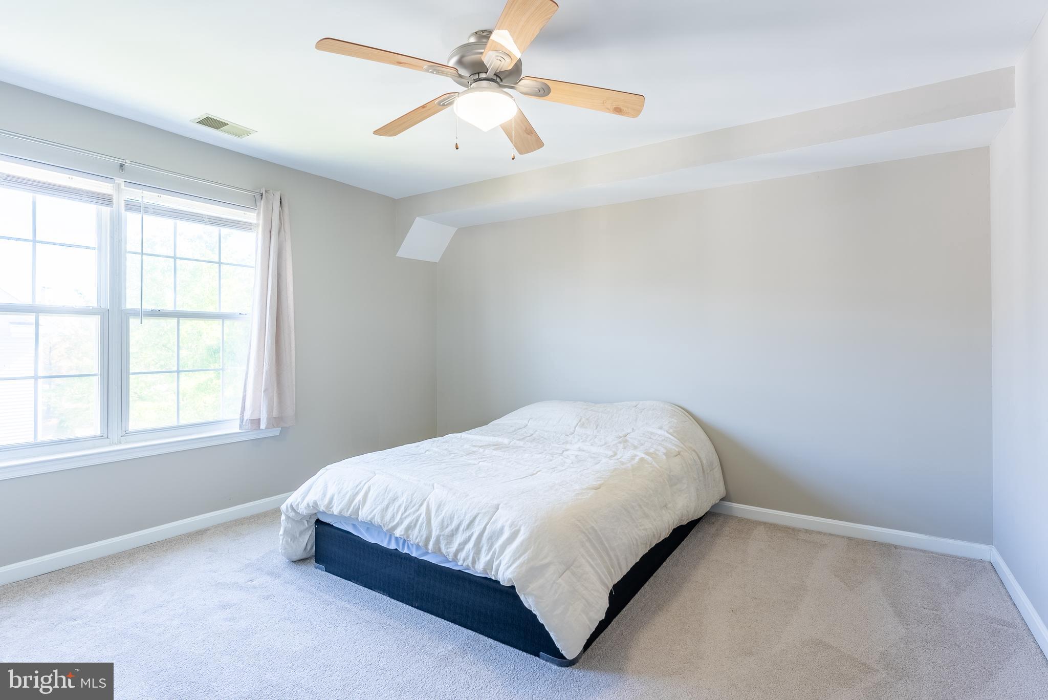 645 Constellation Square Southeast, Unit L Leesburg, VA 20175 - Photo 12 of 44 a bedroom with a bed and window