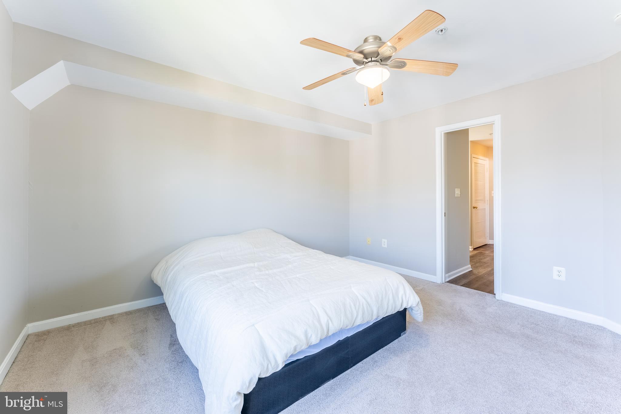 645 Constellation Square Southeast, Unit L Leesburg, VA 20175 - Photo 13 of 44 a bedroom with a bed and a ceiling fan