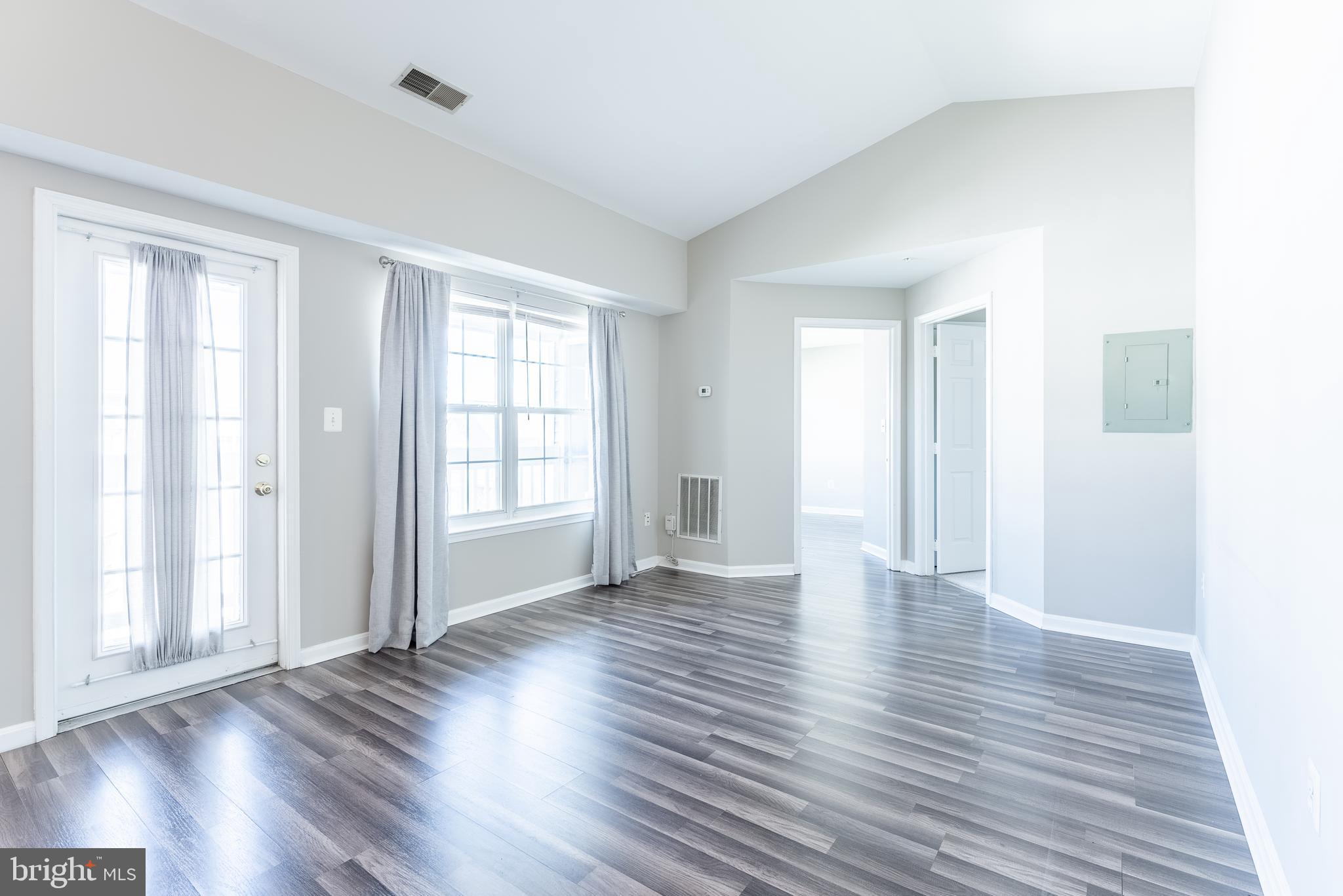 645 Constellation Square Southeast, Unit L Leesburg, VA 20175 - Photo 18 of 44 a view of an empty room with wooden floor and a window
