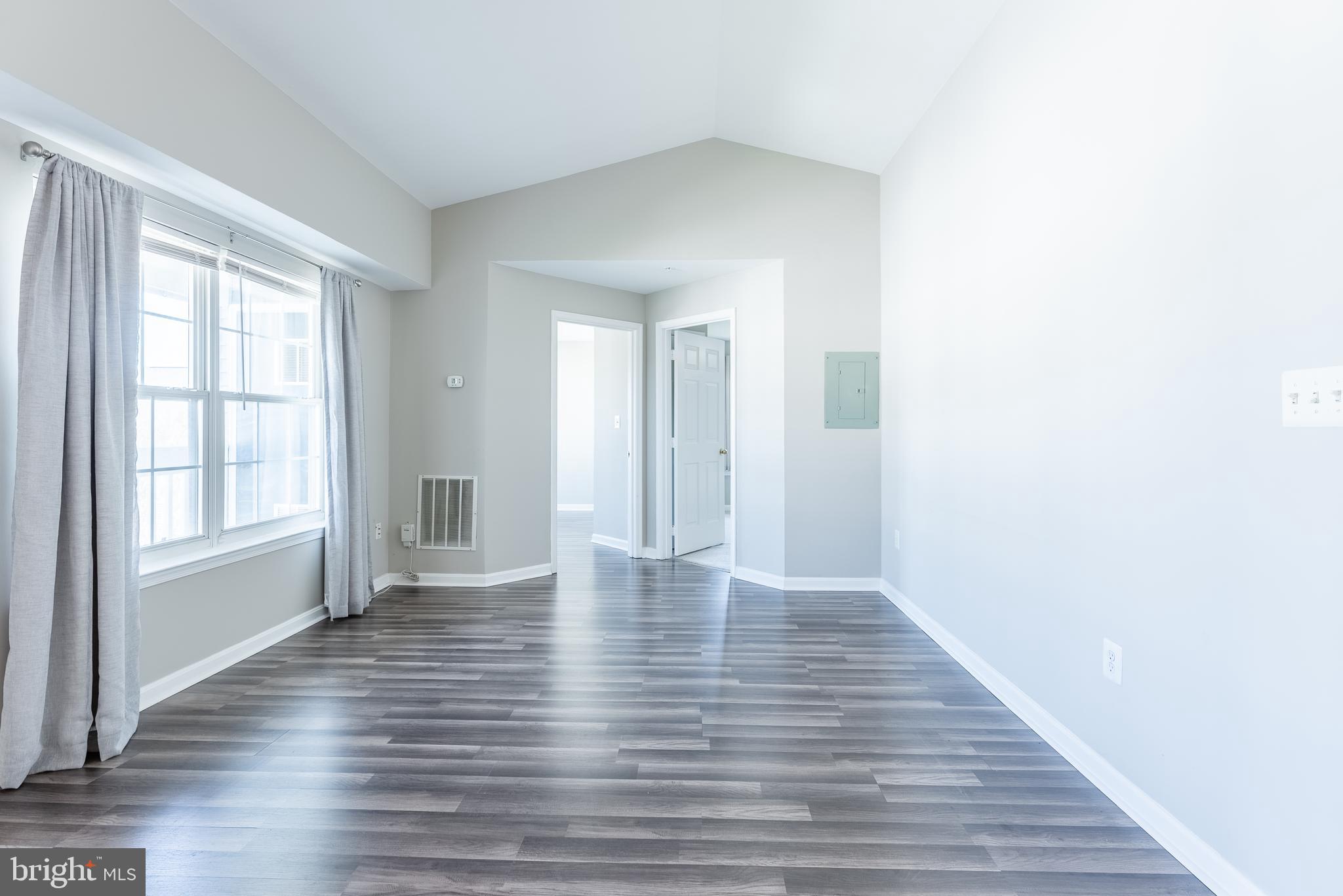 645 Constellation Square Southeast, Unit L Leesburg, VA 20175 - Photo 19 of 44 a view of an empty room with wooden floor and a window