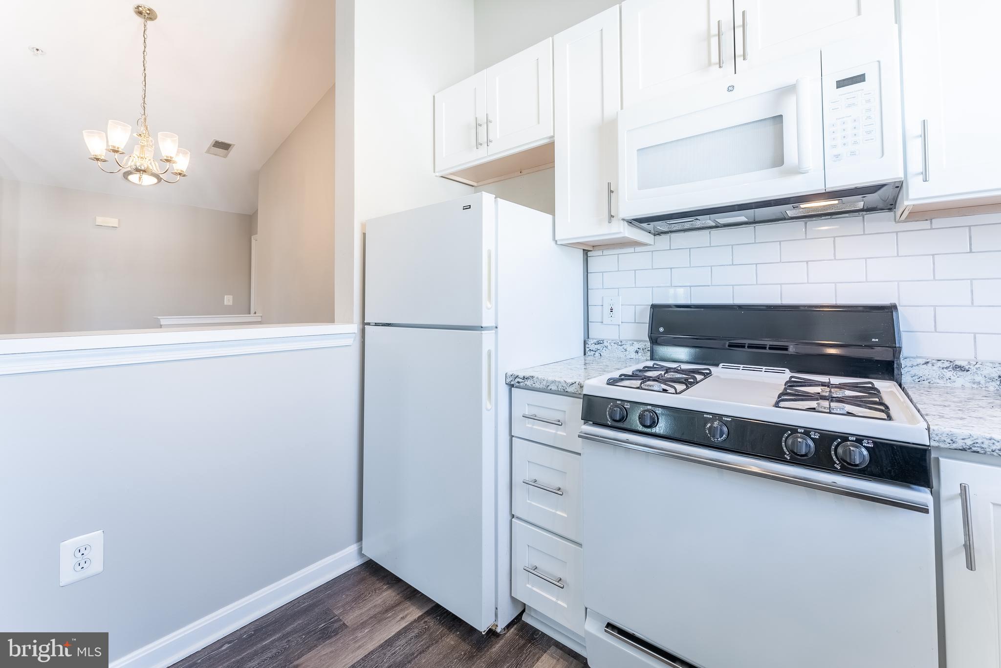 645 Constellation Square Southeast, Unit L Leesburg, VA 20175 - Photo 24 of 44 a kitchen with a stove and a refrigerator