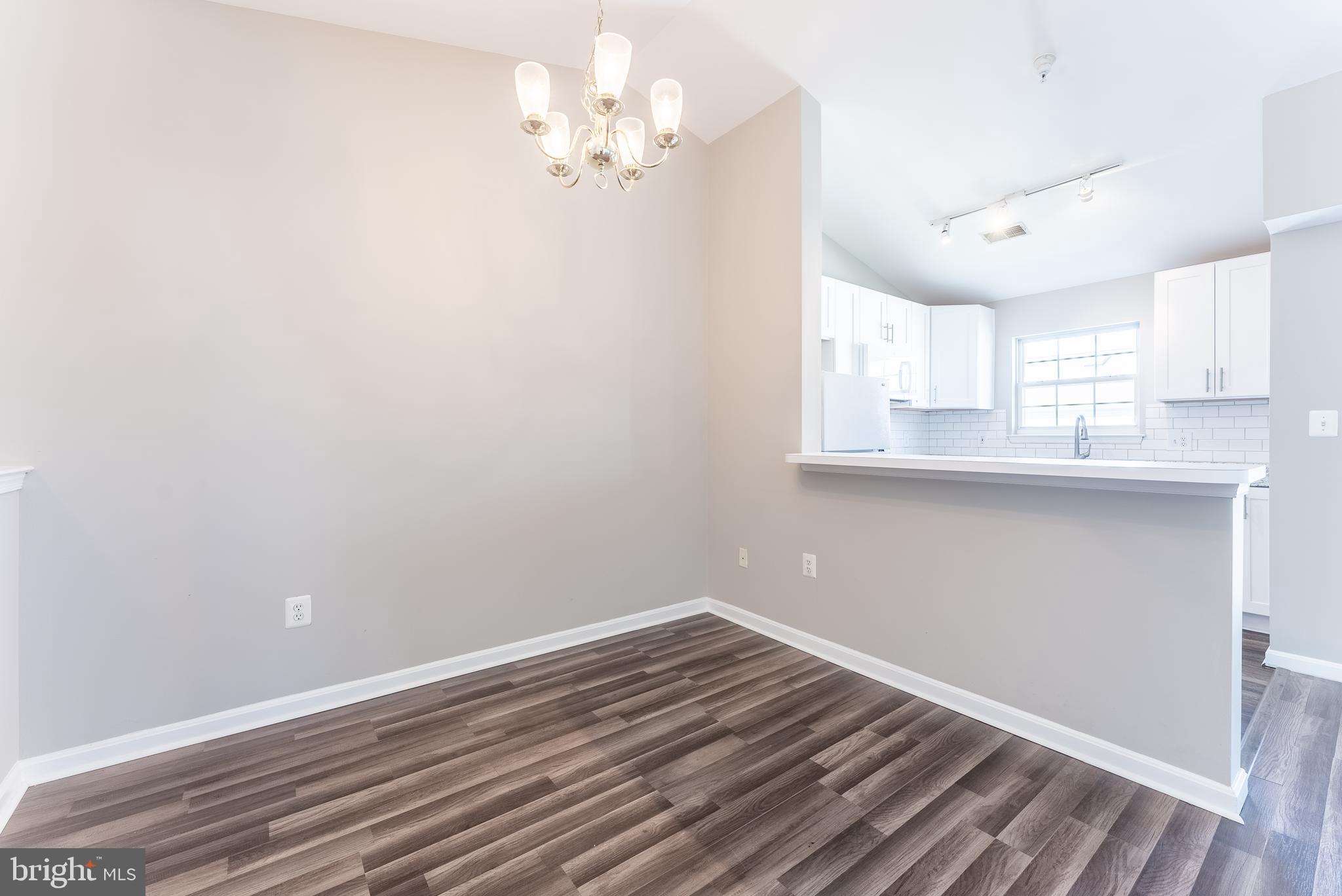 645 Constellation Square Southeast, Unit L Leesburg, VA 20175 - Photo 28 of 44 an empty room with wooden floor and a window