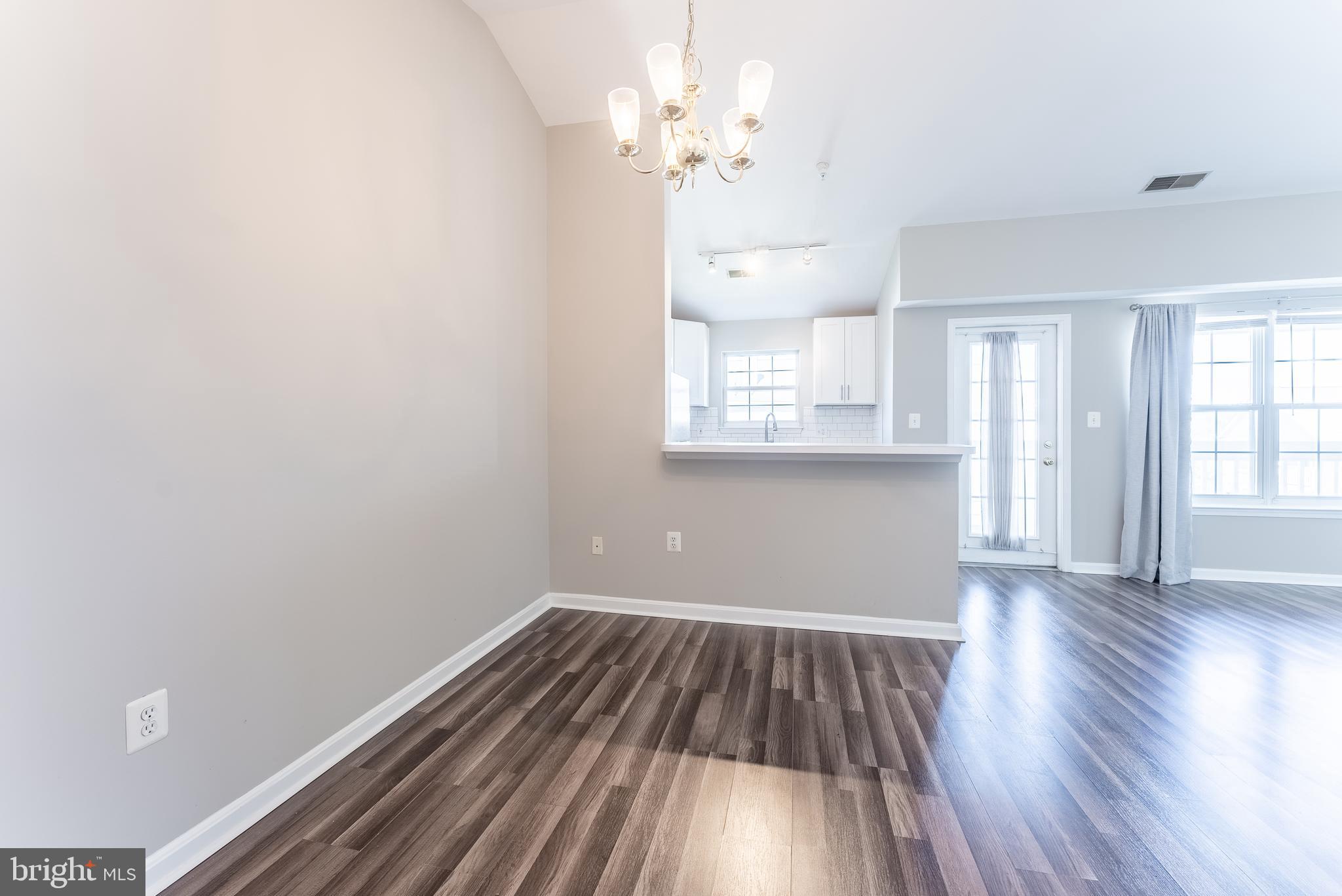 645 Constellation Square Southeast, Unit L Leesburg, VA 20175 - Photo 29 of 44 wooden floor in an empty room with a window