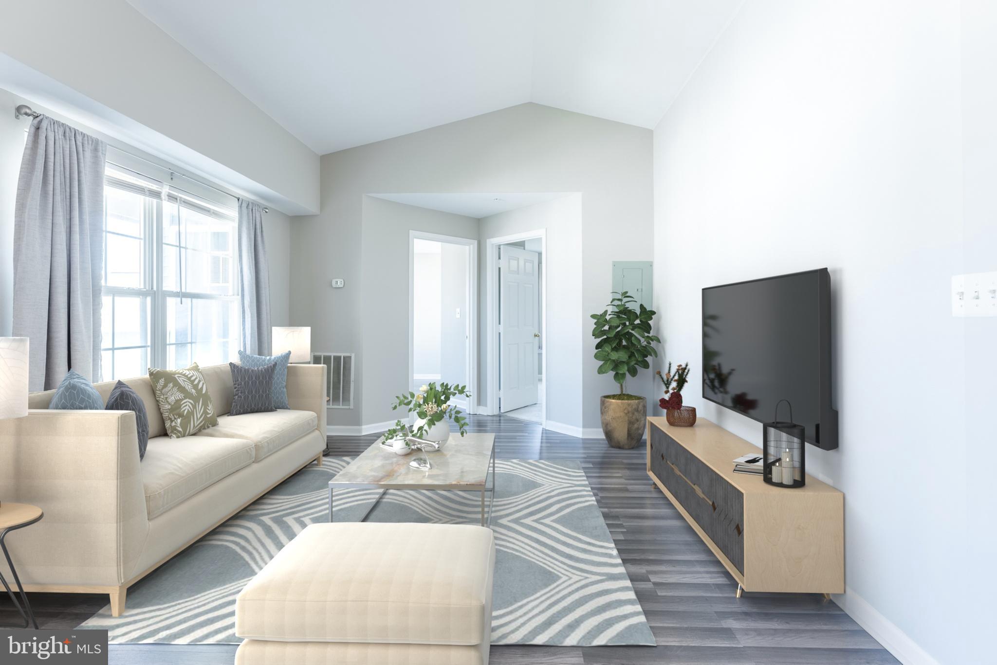 645 Constellation Square Southeast, Unit L Leesburg, VA 20175 - Photo 3 of 44 a living room with furniture and a flat screen tv