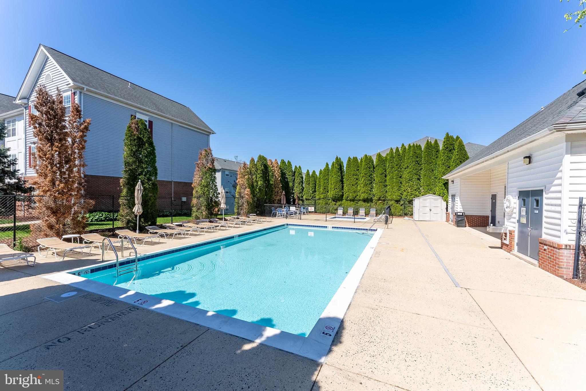 645 Constellation Square Southeast, Unit L Leesburg, VA 20175 - Photo 40 of 44 a view of swimming pool with outdoor seating and house in the background