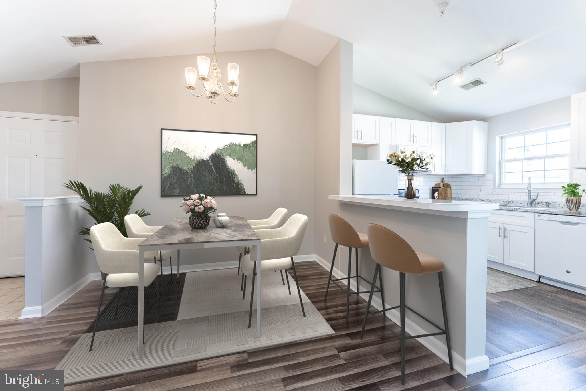 645 Constellation Square Southeast, Unit L Leesburg, VA 20175 - Photo 4 of 44 a dining room with furniture a chandelier and wooden floor