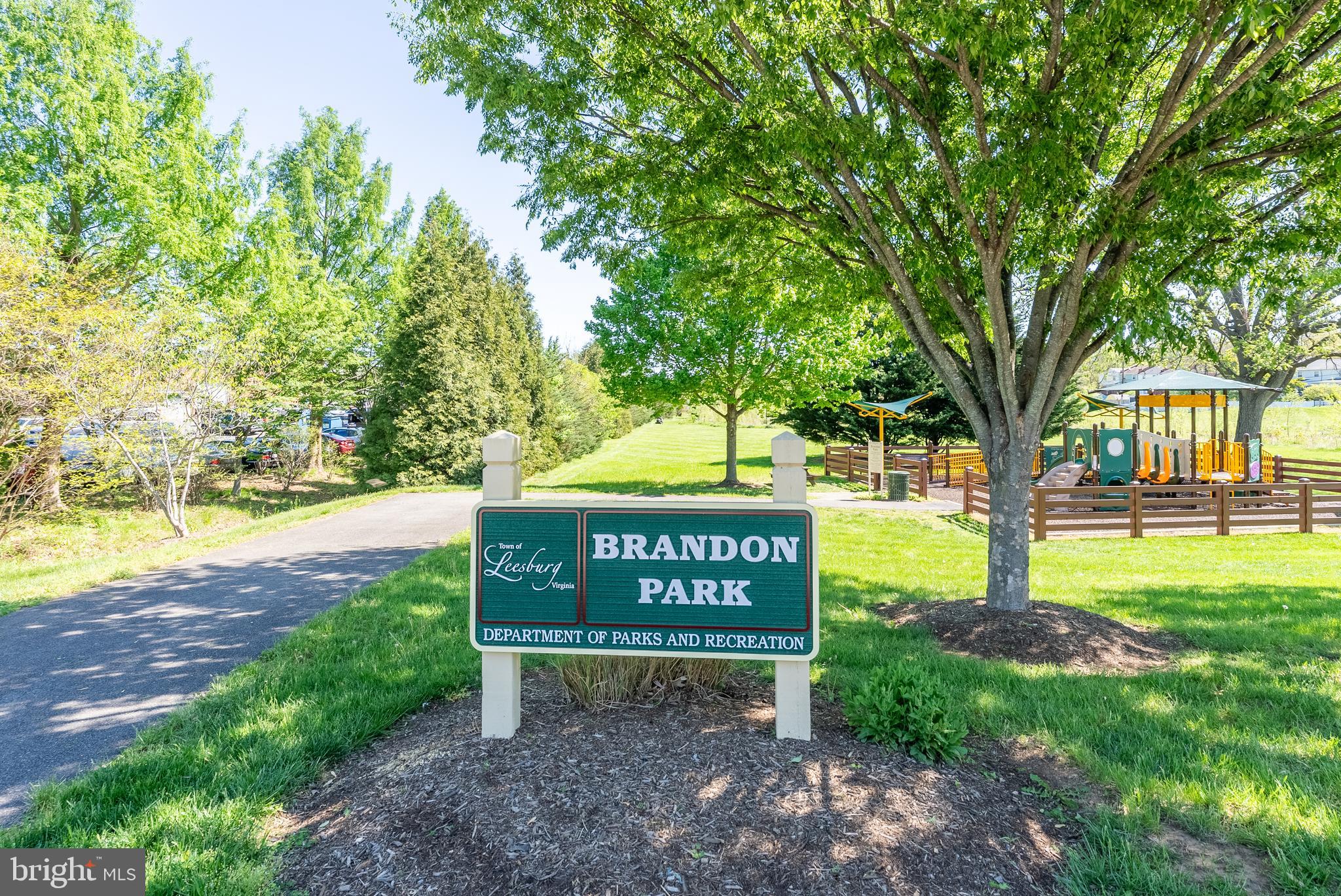 645 Constellation Square Southeast, Unit L Leesburg, VA 20175 - Photo 41 of 44 a sign board with a bench and trees