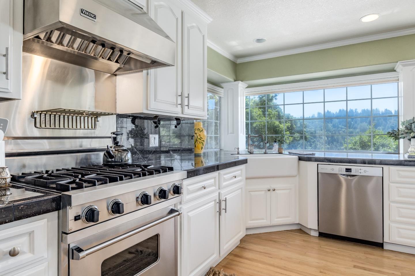 348 Los Robles Road Soquel, CA 95073 - Photo 18 of 87 a kitchen with granite countertop a stove a sink and white cabinets with wooden floor
