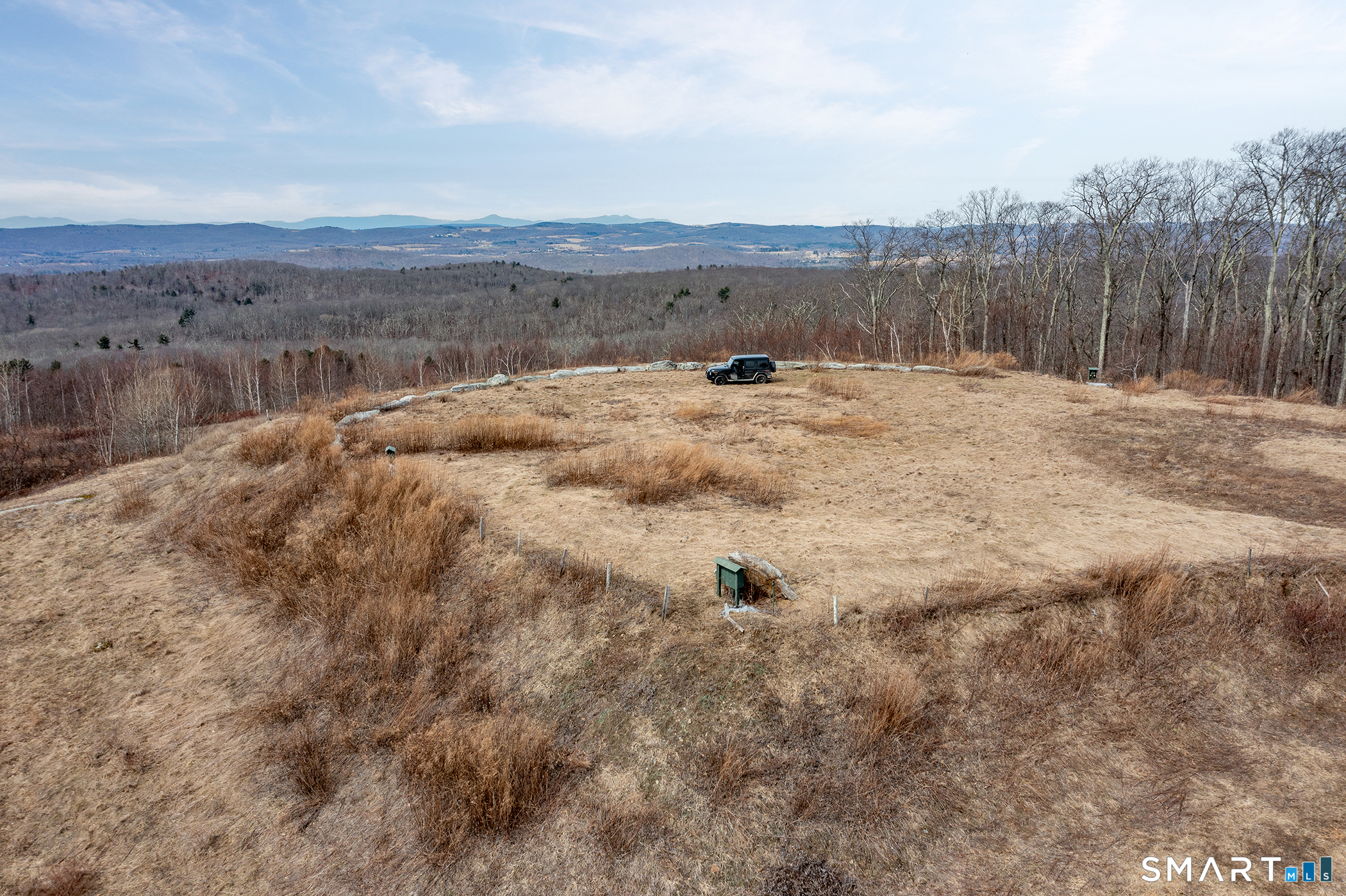Joray Road Sharon, CT 06069 - Photo 4 of 10 a view of a dry yard with mountains in the background