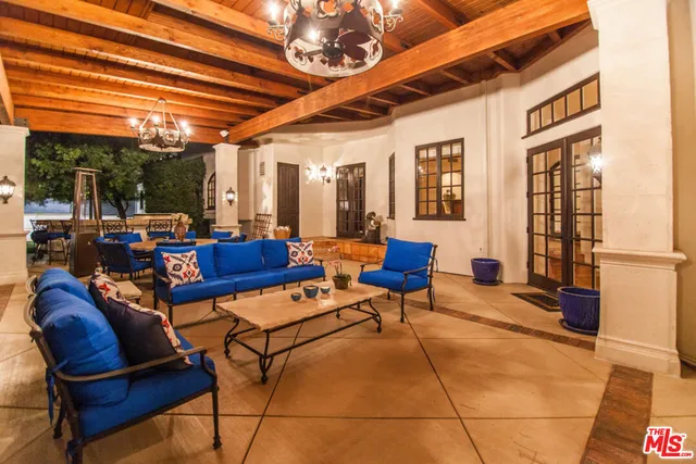 a living room with furniture a dining table and chairs with wooden floor