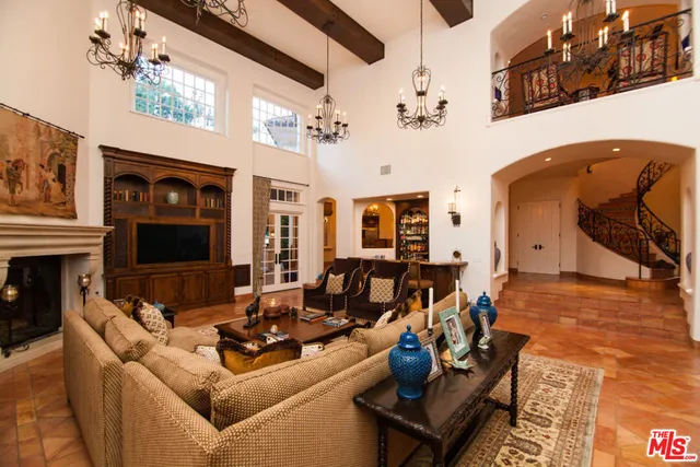 a living room with fireplace furniture and a flat screen tv