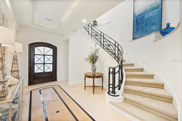 a living room with furniture chandelier and a large window