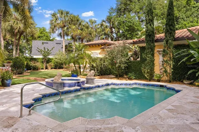 a view of a backyard of a house with a lake view