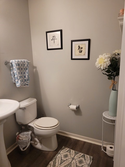 503 Metropolitan Street, Unit 503 Aurora, IL 60502 - Photo 19 of 24 a white toilet sitting next to a bathroom sink
