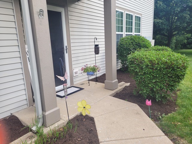 503 Metropolitan Street, Unit 503 Aurora, IL 60502 - Photo 6 of 24 a view of a backyard with plants and outdoor seating