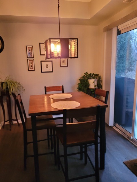 503 Metropolitan Street, Unit 503 Aurora, IL 60502 - Photo 10 of 24 a view of a dining room with furniture wooden floor and chandelier