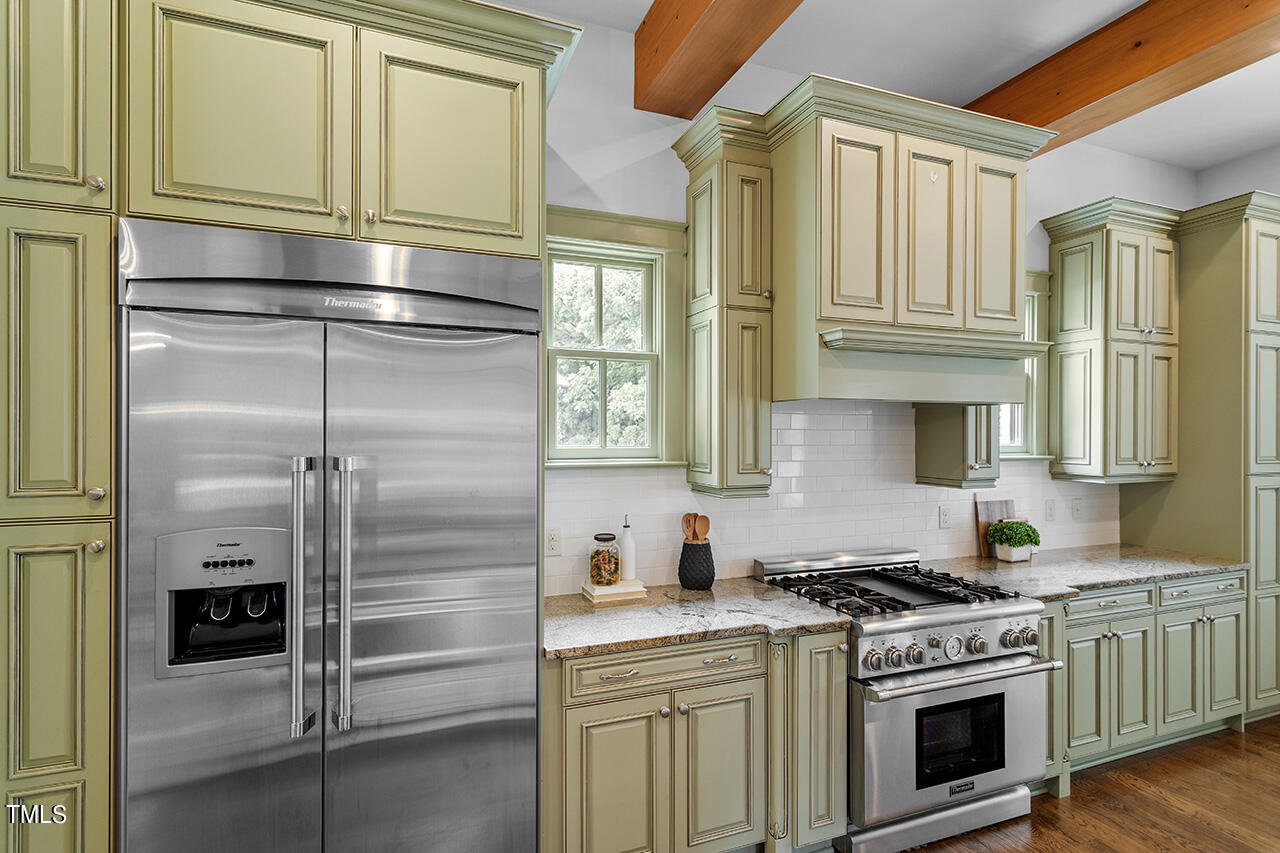 2000 Greyhawk Place Apex, NC 27539 - Photo 23 of 59 a kitchen with stainless steel appliances granite countertop a refrigerator and a stove