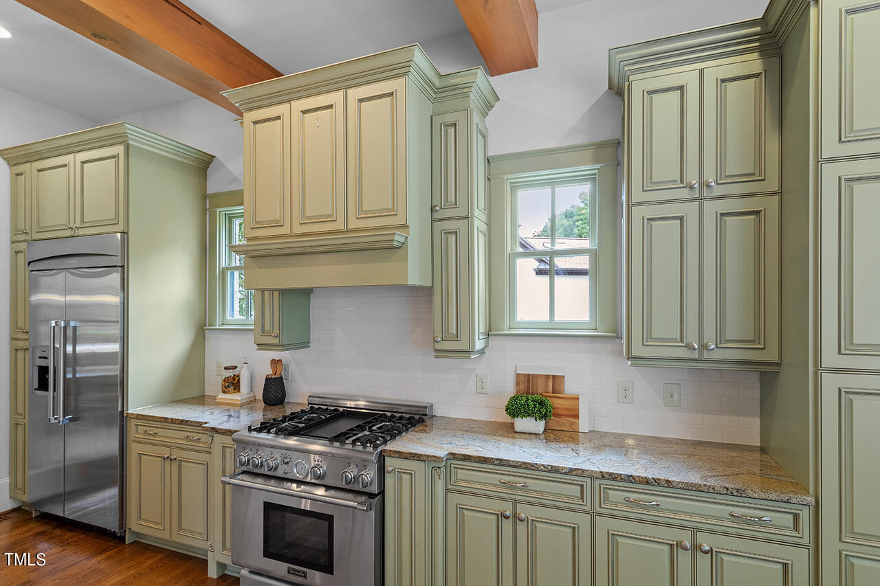 2000 Greyhawk Place Apex, NC 27539 - Photo 24 of 59 a kitchen with stainless steel appliances granite countertop a refrigerator a stove and a sink