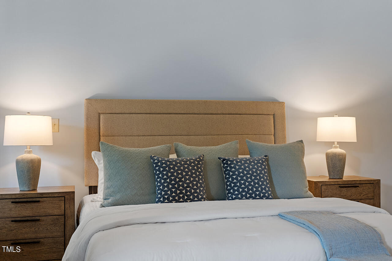 2000 Greyhawk Place Apex, NC 27539 - Photo 28 of 59 a bedroom with a bed and lamp