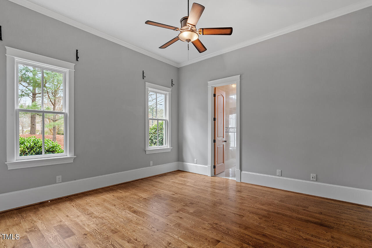 2000 Greyhawk Place Apex, NC 27539 - Photo 32 of 59 a view of an empty room with window and wooden floor