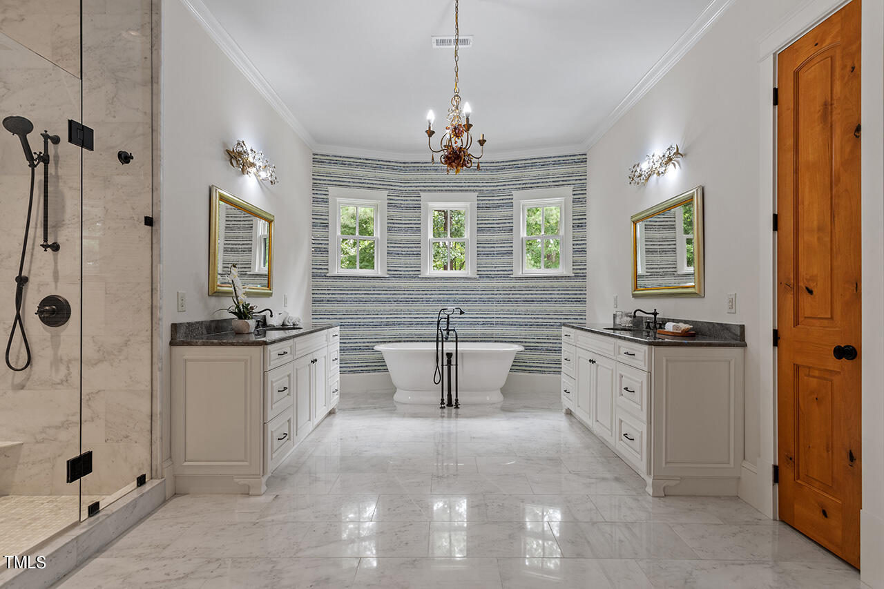 2000 Greyhawk Place Apex, NC 27539 - Photo 34 of 59 a large spacious bathroom with a granite countertop sink a large mirror and a bathtub