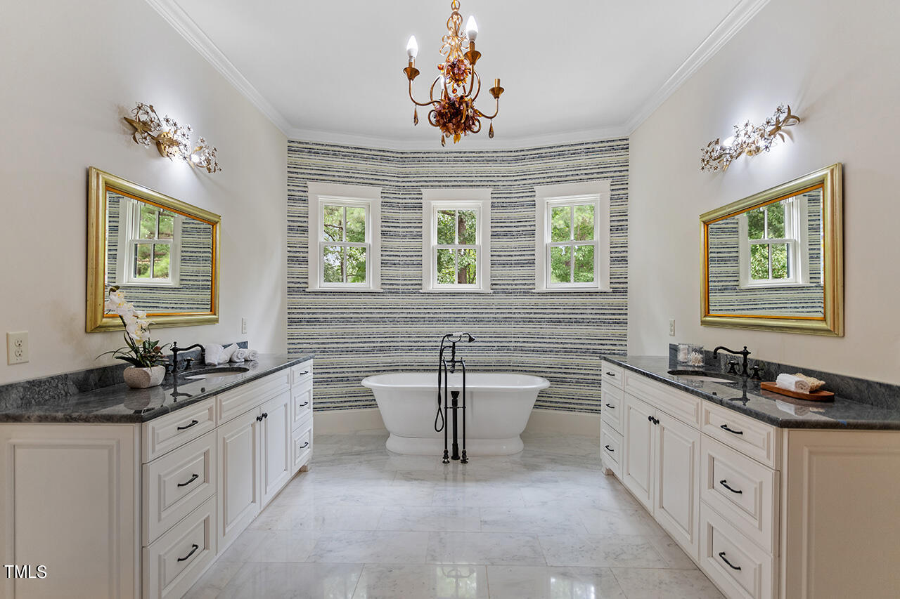 2000 Greyhawk Place Apex, NC 27539 - Photo 36 of 59 a spacious bathroom with double sink a window a mirror a bathtub and window