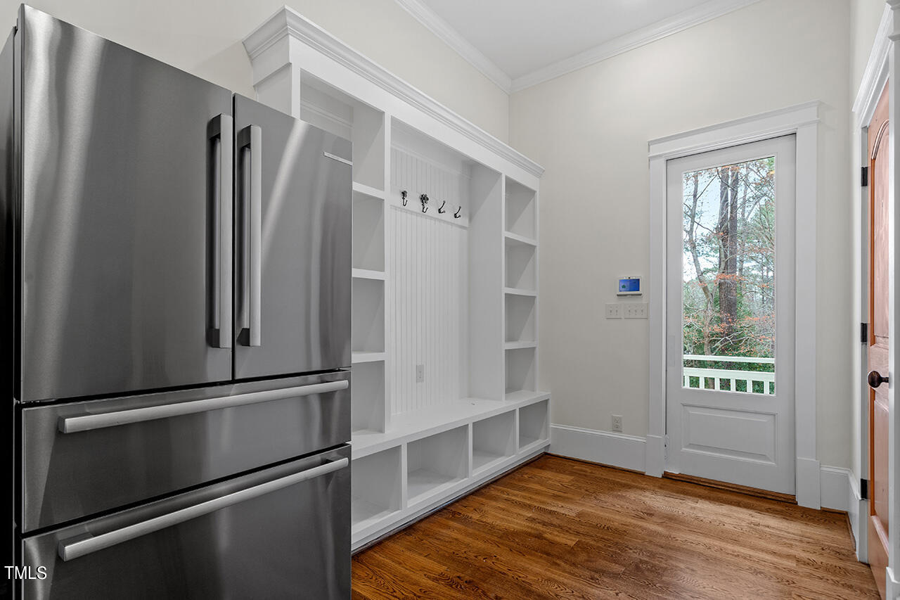 2000 Greyhawk Place Apex, NC 27539 - Photo 37 of 59 a view of an empty room with wooden floor and a window