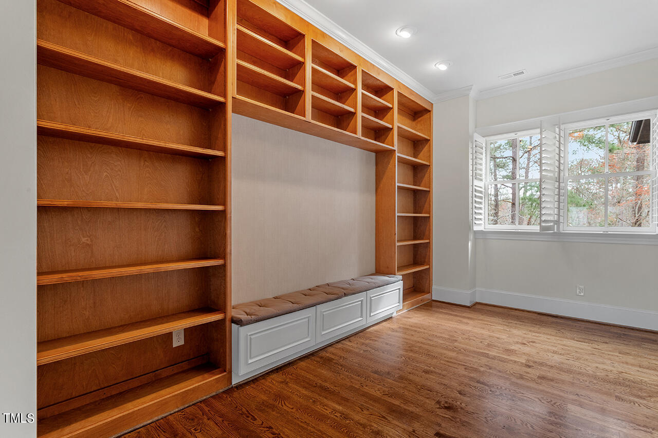 2000 Greyhawk Place Apex, NC 27539 - Photo 39 of 59 a view of an empty room with wooden floor and a window