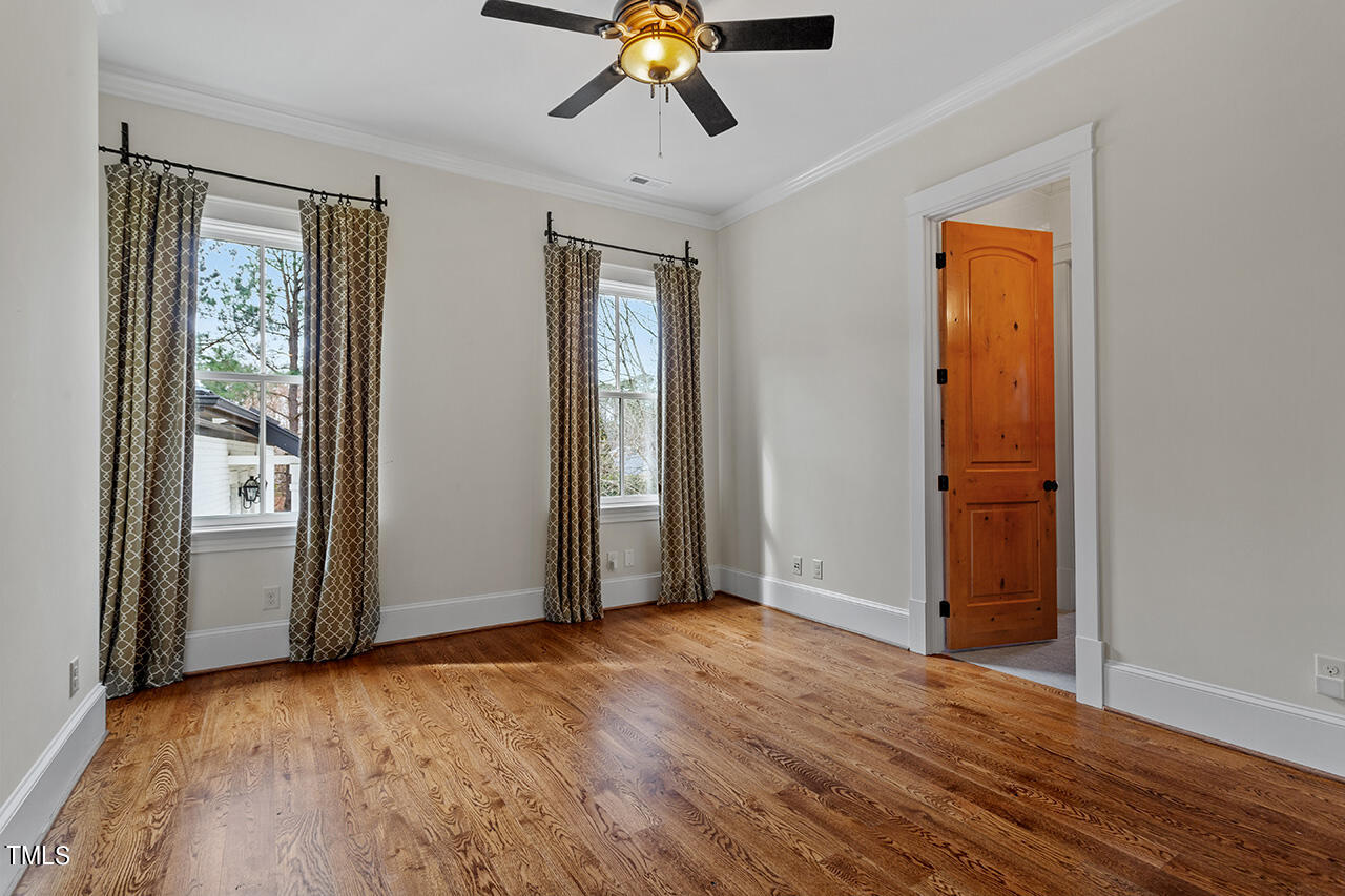 2000 Greyhawk Place Apex, NC 27539 - Photo 40 of 59 an empty room with wooden floor and windows