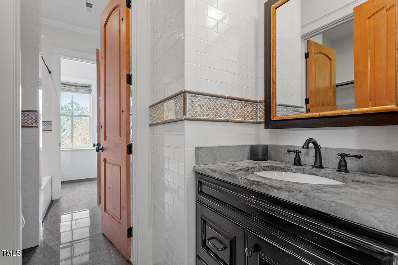 2000 Greyhawk Place Apex, NC 27539 - Photo 42 of 59 a kitchen with granite countertop a sink and cabinets