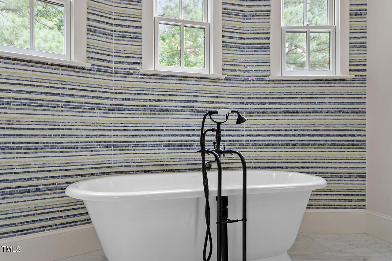 2000 Greyhawk Place Apex, NC 27539 - Photo 44 of 59 a bathroom with a bathtub and a window