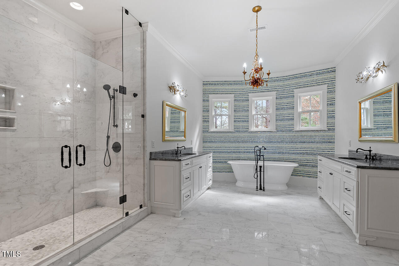 2000 Greyhawk Place Apex, NC 27539 - Photo 47 of 59 a bathroom with a granite countertop sink a toilet a mirror and shower