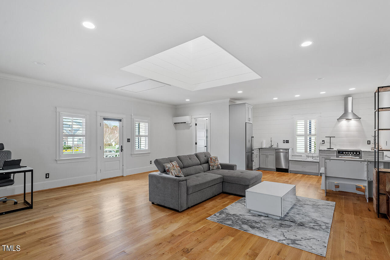 2000 Greyhawk Place Apex, NC 27539 - Photo 52 of 59 a living room with furniture and a wooden floor