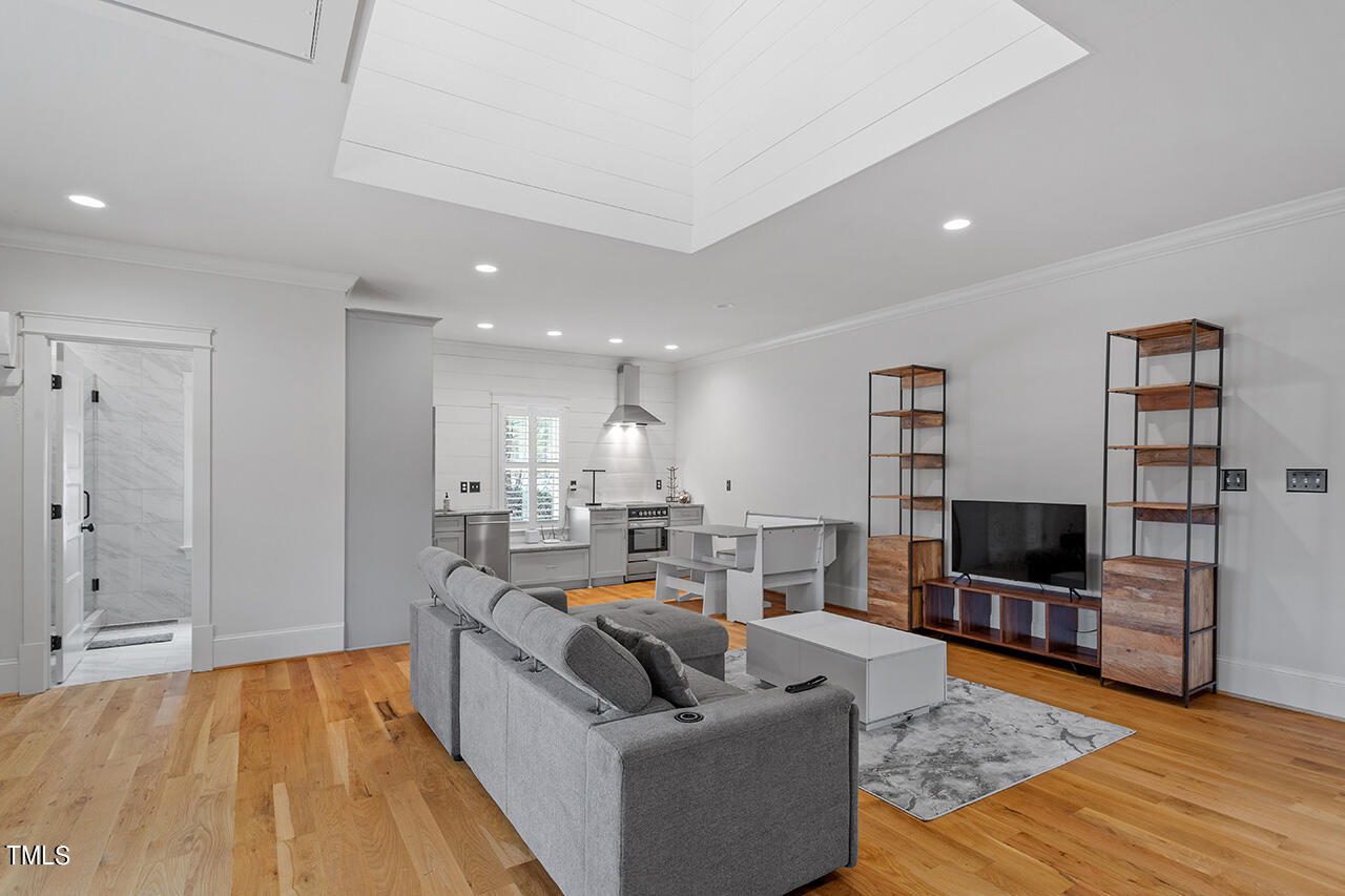 2000 Greyhawk Place Apex, NC 27539 - Photo 53 of 59 a living room with furniture and a flat screen tv