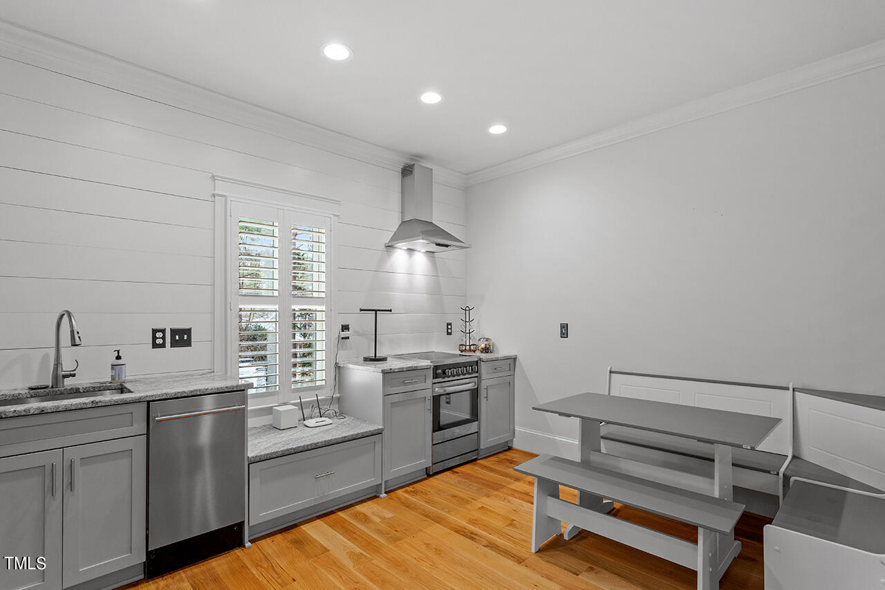 2000 Greyhawk Place Apex, NC 27539 - Photo 54 of 59 a kitchen with kitchen island granite countertop a sink cabinets and stainless steel appliances