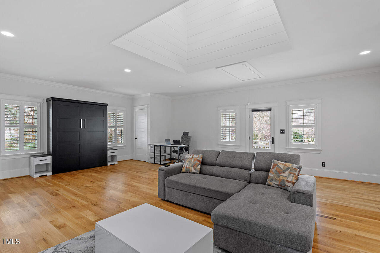 2000 Greyhawk Place Apex, NC 27539 - Photo 56 of 59 a living room with furniture window and a wooden floor